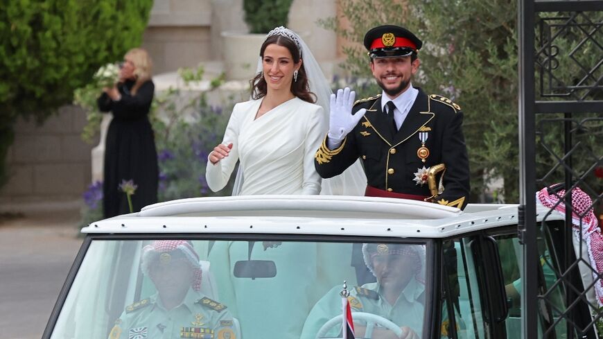 Jordan's Crown Prince Hussein and his Saudi wife Rajwa Al Seif wave as they leave the Zahran Palace in Amman