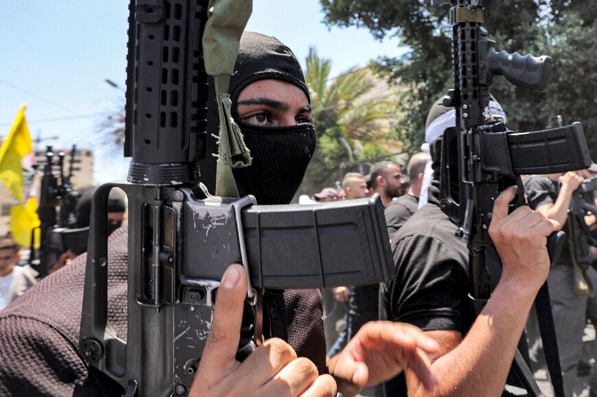 Palestinian militants march during the funeral of Palestinians killed in clashes in the Israeli military operation in Jenin in the occupied West Bank 