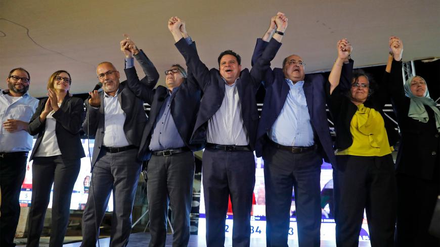 (L to R) Ofer Cassif, Jewish member and candidate for the Hadash (Democratic Front for Peace and Equality) party that is part of the Joint List alliance, applauds with Heba Yazbak, member and candidate for the Balad (National Democratic Alliance) party as Osama Saadi, member and candidate for the Arab Movement for Change (Taal) party raises his hands together with Balad party member and candidate Mtanes Shehadeh, Hadash's chairman and candidate Ayman Odeh, Taal's leader and candidate Ahmad Tibi, Hadash's me