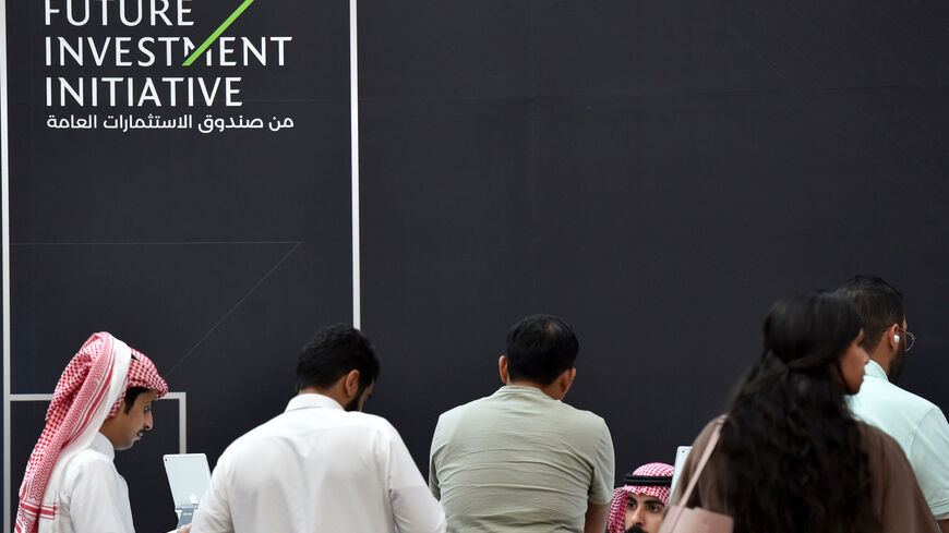 Saudi and foreign journalists are pictured at the Future Investment Initiative (FII) badge collection centre.