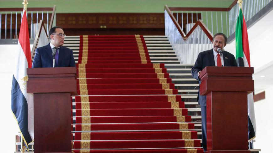 Egyptian Prime Minister Mostafa Madbouli (L) and his Sudanese counterpart Abdalla Hamdok address the press after their meeting in Sudan's capital Khartoum, on August 15, 2020. (Photo by ASHRAF SHAZLY / AFP) (Photo by ASHRAF SHAZLY/AFP via Getty Images)