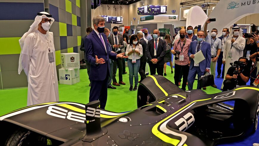 The United Arab Emirates' (UAE) minister of industry and advanced technology, Sultan al-Jaber (L), looks on as John Kerry, the US president's climate envoy, tours the Global Manufacturing and Industrialisation (GMIS) Summit in Dubai on November 22, 2021. (Photo by AFP) (Photo by -/AFP via Getty Images)