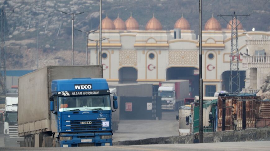A convoy transporting humanitarian aid crosses into Syria from Turkey through the Bab al-Hawa border crossing on Jan. 18, 2022.