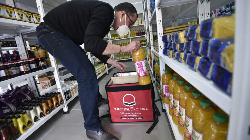 An employee prepares a basket of groceries at the storage department of the Algerian delivery company Yassir, in the capital Algiers on February 23, 2022. - It's the Algerian start-up that made good: despite the country's notoriously complex business climate, taxi and home-delivery firm Yassir has millions of users and is expanding across Africa. (Photo by RYAD KRAMDI / AFP) (Photo by RYAD KRAMDI/AFP via Getty Images)