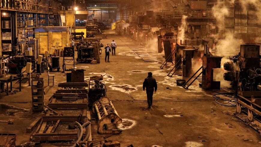 Steel workers walk at the Iran National Steel Industrial Group facility in Ahvaz in Iran's southwestern Khuzestan province on December 22, 2020. (Photo by Reza SOLEYMANI ROUZBEHANI / ISNA / AFP) (Photo by REZA SOLEYMANI ROUZBEHANI/ISNA/AFP via Getty Images)