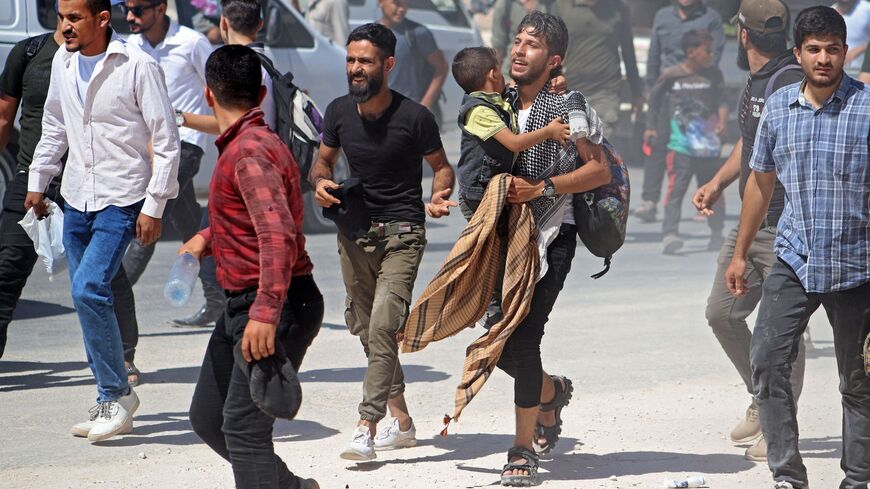 Syrians gather in front of the Bab al-Hawa border crossing with Turkey on Sept. 12, 2022.