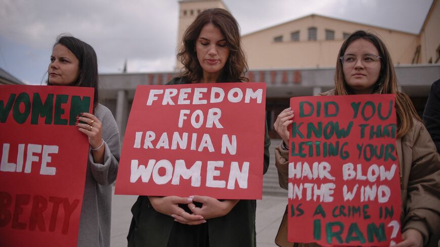 Women take part in a rally in support of Iranian women in Pristina on Oct. 12, 2022.