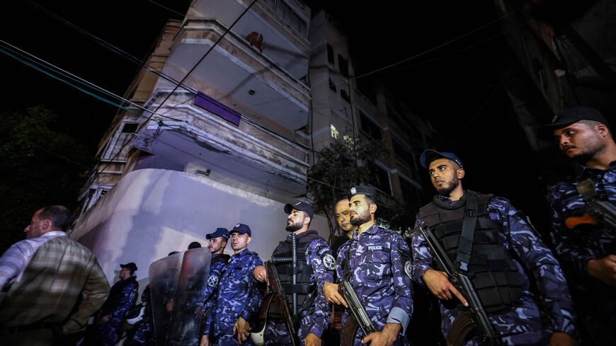 Police officers cordon off the area surrounding a building as firefighters extinguish a fire that broke out in one of the apartments in the Jabalia camp for Palestinian refugees, northern Gaza strip, Nov. 17, 2022.