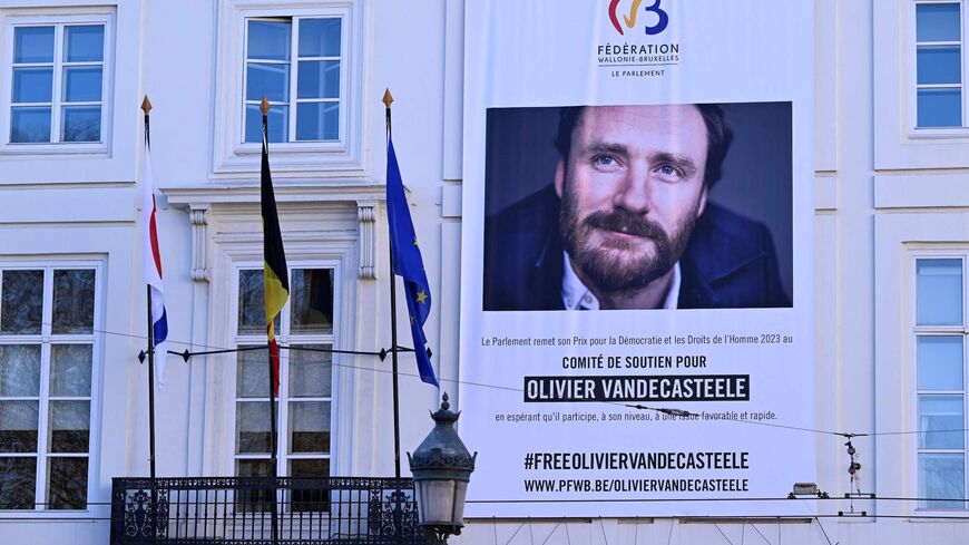 This photograph taken on Feb. 8, 2023, shows a large banner with a portrait of Belgian aid worker Olivier Vandecasteele.