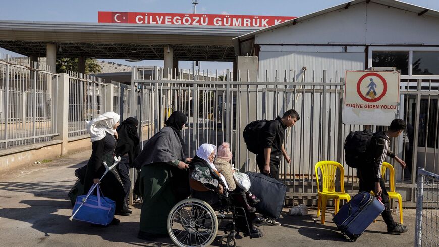 Syrian refugees living in the earthquake-affected areas of southeastern Turkey cross the Turkey-Syria border at the Cilvegozu border crossing, Turkey, February 19, 2023. A 7.8-magnitude earthquake struck the country's south-east in the early hours of February 6, followed by another 7.5-magnitude tremor just after midday. The quakes caused widespread destruction in southern Turkey and northern Syria, leaving behind more than 46,000 dead. (Photo by Konstantinos Tsakalidis / SOOC / SOOC via AFP) (Photo by KONS