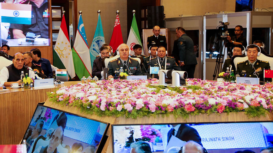 This handout photograph released by the Indian Ministry of Defense shows India's Defense Minister Rajnath Singh, Kazakhstan Defense Minister Col. Gen. Ruslan Zhaxylykov (C) and Chinese Defense Minister Gen. Li Shangfu (R) attending the Shanghai Cooperation Organization meeting in New Delhi, India, April 28, 2023.