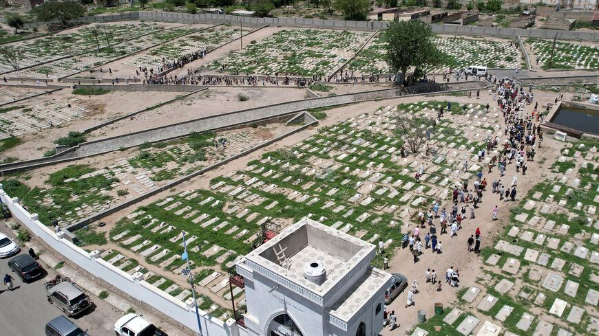 An aerial picture shows people visiting the "Martyrs Cemetery" which was opened at the beginning of the Yemen conflict in the city of Taez on May 6, 2023. - Yemen has been shattered by a nearly-decade-long civil war which has claimed hundreds of thousands of lives and plunged the country into a severe humanitarian crisis. (Photo by AHMAD AL-BASHA / AFP) (Photo by AHMAD AL-BASHA/AFP via Getty Images)