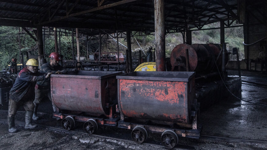 Coal miners move a wagon of coal at a small coal mine on Dec. 9, 2021, in Zonguldak, Turkey. 