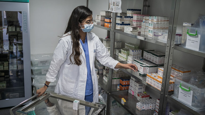 A doctor in the oncology department of the Hotel-Dieu de France reviews anticancer drugs in the hospital pharmacy, Beirut, Lebanon, Oct. 7, 2022.