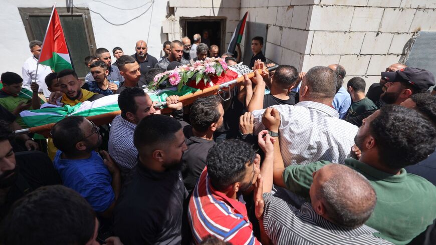 Mourners carry the body of 19-year-old Palestinian Qusai Jamal Maatan.