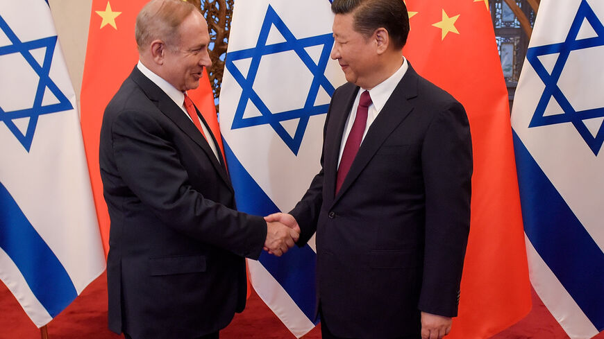 Chinese President Xi Jinping (R) and Israeli Prime Minister Benjamin Netanyahu (L) shake hands ahead of their talks at Diaoyutai State Guesthouse on March 21, 2017 in Beijing, China. (Photo by Etienne Oliveau/Pool/Getty Images)