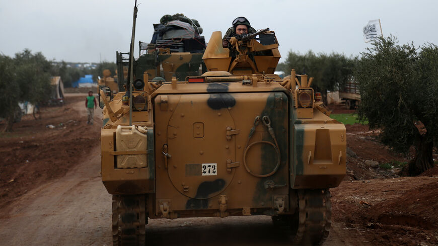 A Turkish soldier mans a turret on an infantry fighting vehicle driving near the village of Yazi Bagh.