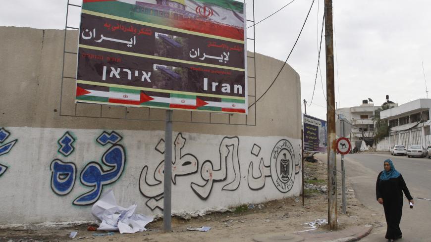 A Palestinian woman walks next to a banner that reads "Thanks and gratitude to Iran" in Gaza City November 27, 2012. Senior Hamas leader Mahmoud al-Zahar showed how fragile the ceasefire between Israel and Palestinians remained, with defiant remarks to reporters recently of how the Islamists would go on smuggling in weapons "by all possible means", including via Israel's arch-foe Iran. REUTERS/Ahmed Zakot (GAZA - Tags: CIVIL UNREST CONFLICT) - GM1E8BR1MY501