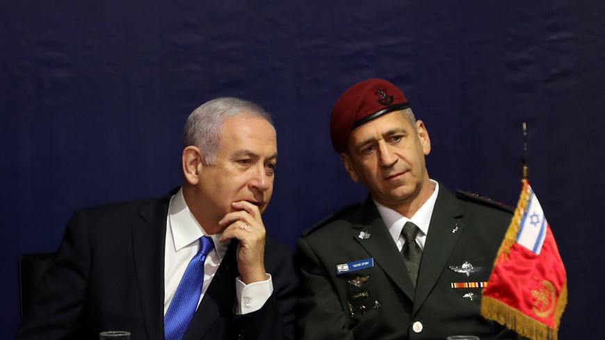 Israeli Prime Minister Benjamin Netanyahu speaks with incoming Israeli Chief of Staff Aviv Kohavi during a ceremony whereby he replaces Lieutenant-General Gadi Eizenkot, at the Defense Ministry in Tel Aviv, Israel January 15, 2019. REUTERS/Corinna Kern - RC116DA9AC60