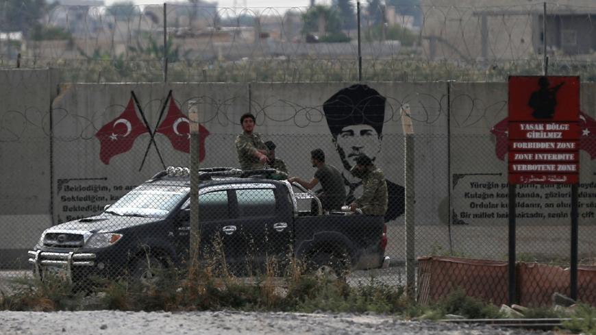 Turkey-backed Syrian rebel fighters return from the Syrian border town of Tal Abyad, as they are pictured on the Turkish-Syrian border in Akcakale, Turkey, October 20, 2019. REUTERS/Stoyan Nenov - RC1677531AA0