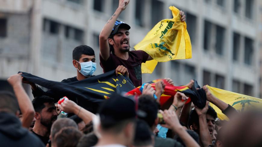 Supporters of Lebanon's Hezbollah leader Sayyed Hassan Nasrallah carry the party's flag in Beirut, Lebanon, October 25, 2019. REUTERS/Mohamed Azakir - RC1916F5C910