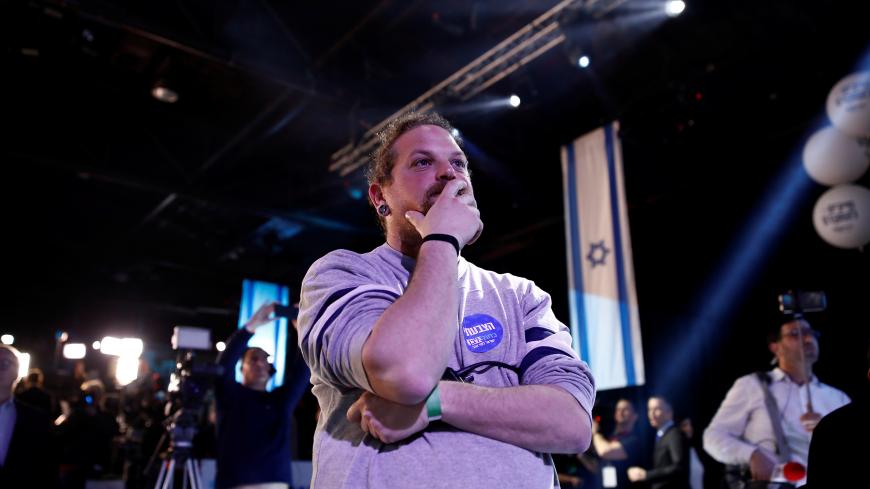 A supporter reacts as results of the exit polls are shown at Benny Gantz's Blue and White party headquarters, following Israel's national election, in Tel Aviv, Israel March 2, 2020. REUTERS/Corinna Kern - RC2WBF9A844E