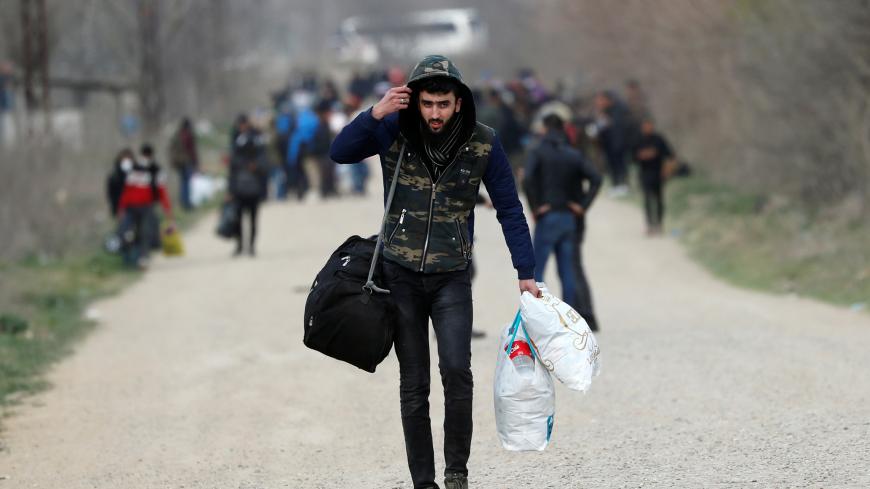 A migrant walks near Turkey's Pazarkule border crossing with Greece's Kastanies, in Edirne, Turkey, March 10, 2020. REUTERS/Murad Sezer - RC2WGF9OOAQ1