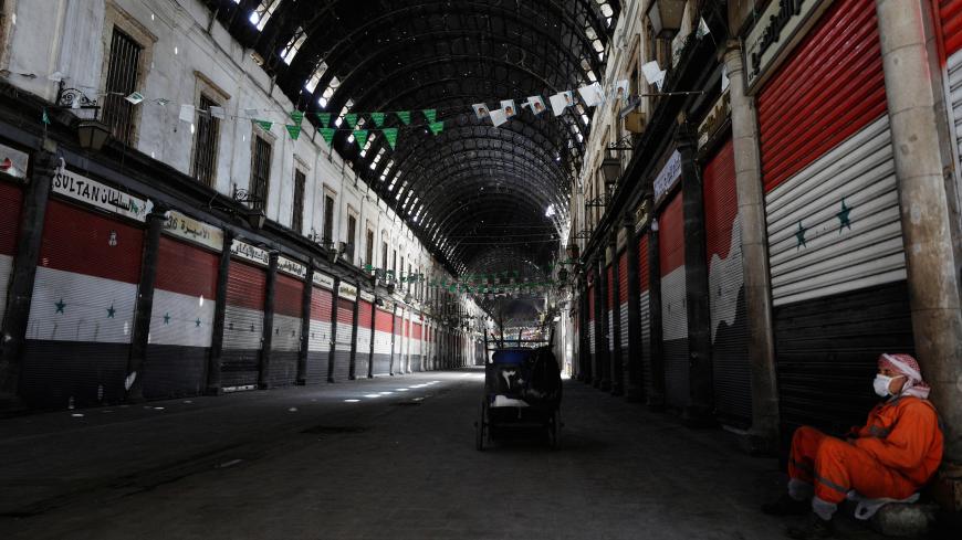 A street cleaner rests at empty Souk al-Hamidieh, as restrictions are imposed as measure to prevent the spread of the coronavirus disease (COVID-19) in Damascus, Syria March 24, 2020. REUTERS/Omar Sanadiki - RC2HQF9TCDQH