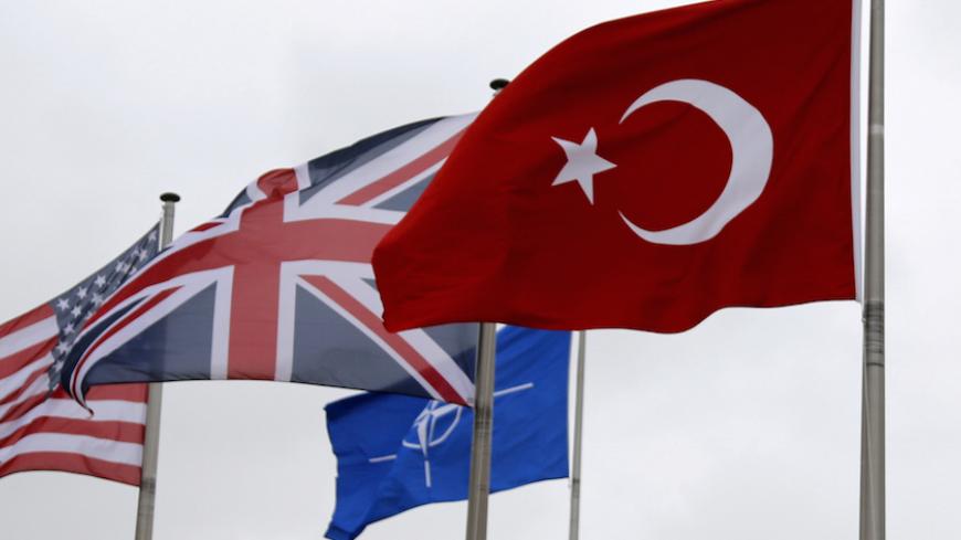 A Turkish flag (R) flies among others flags of NATO members during the North Atlantic Council (NAC) at the Alliance headquarters in Brussels, Belgium, July 28, 2015. REUTERS/Francois Lenoir/File Photo - RTSRWLT