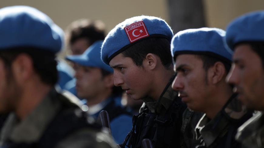 A member of the Free police, wearing a Turkish flag on his hat, attends a ceremony celebrating the inauguration of the "Free Police" in the Syrian border town of Jarablus January 24, 2017. REUTERS/Khalil Ashawi - RC11B36CD250