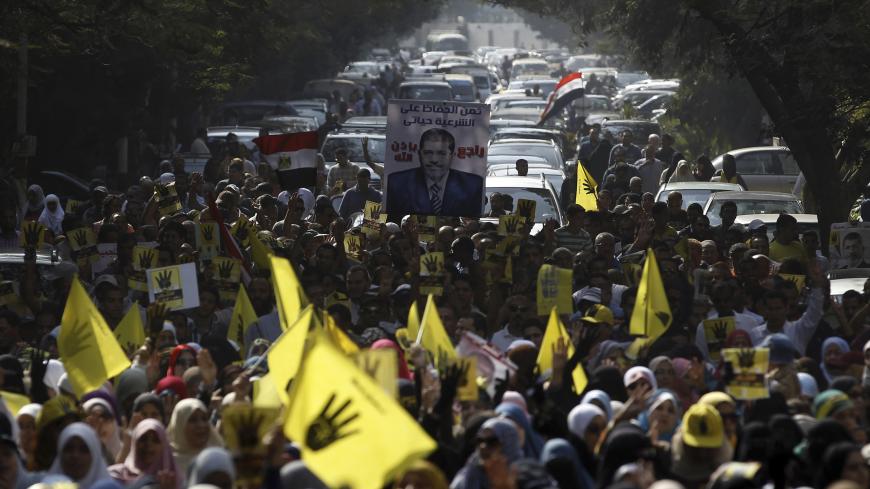 Supporters of the Muslim Brotherhood and ousted Egyptian President Mohamed Mursi take part in a protest against the military and interior ministry in the southern suburb of Maadi, on the outskirts of Cairo November 1, 2013. U.S. Secretary of State John Kerry will visit Egypt a day before deposed Islamist President Mohamed Mursi goes on trial, the next likely flashpoint in the struggle between his Muslim Brotherhood and the army-backed interim government. Several hundred Islamists protested in a few cities o