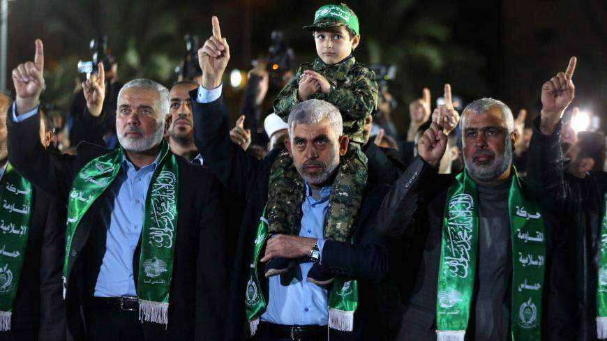 The son of senior Hamas militant Mazen Fuqaha sits on the shoulders of Hamas Gaza Chief Yehya Al-Sinwar during a memorial service for Fuqaha, in Gaza City March 27, 2017. REUTERS/Mohammed Salem     TPX IMAGES OF THE DAY - RC1570813F60