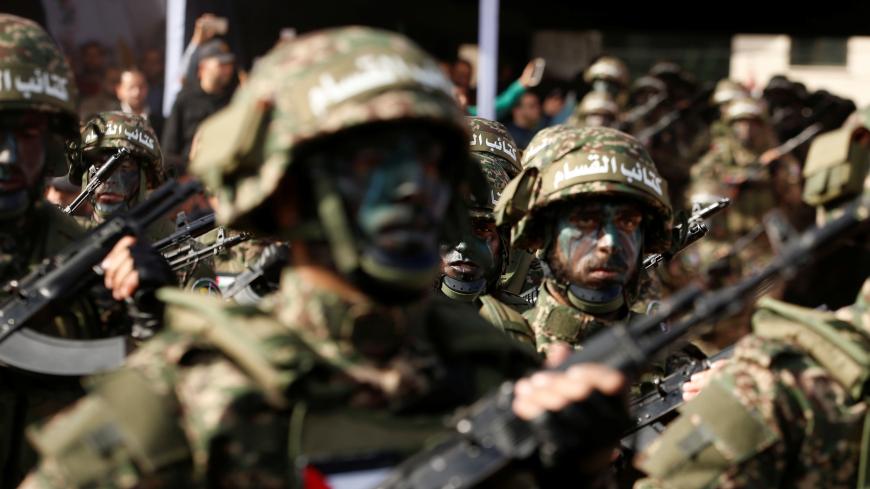 Palestinian Hamas militants take part in a rally marking the 30th anniversary of Hamas' founding, in Gaza City December 14, 2017. REUTERS/Mohammed Salem - RC1E83709490