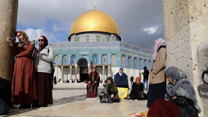 Worshippers sit around before Friday prayers on the compound known to Muslims as Noble Sanctuary and to Jews as Temple Mount in Jerusalem's Old City, as Palestinians call for a "Day of Rage" in response to President Donald Trump's recognition of Jerusalem as Israel's capital December 15, 2017 REUTERS/Ammar Awad