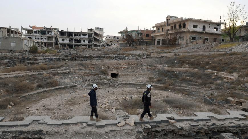 Members of the Civil Defence, also known as the 'White Helmets', are seen inspecting the damage at a Roman ruin site in Daraa, Syria December 23, 2017. REUTERS/Alaa al-Faqir - RC1DDC3A3F50