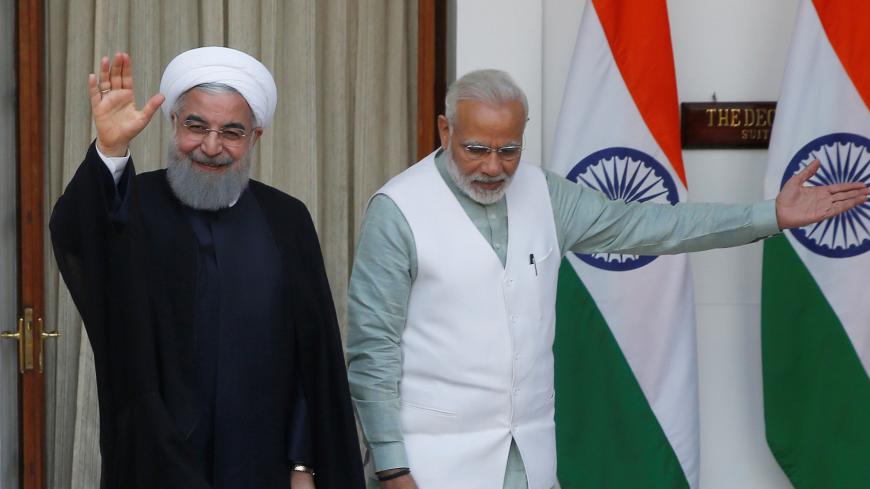 Iranian President Hassan Rouhani waves as India's Prime Minister Narendra Modi (R) gestures during a photo opportunity ahead of their meeting at Hyderabad House in New Delhi, India, February 17, 2018. REUTERS/Adnan Abidi - RC12E8F257F0