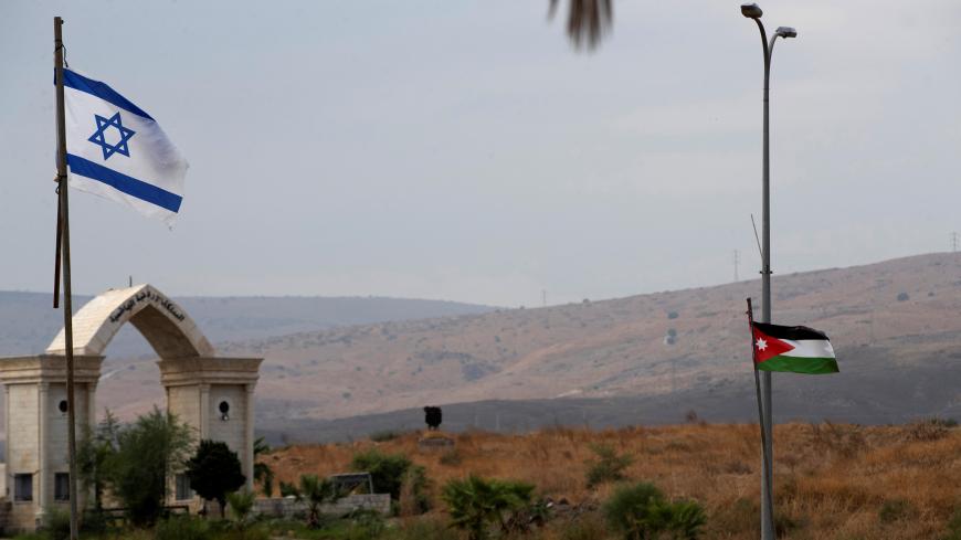 The national flags of Jordan and Israel are seen from the Israeli side of the border area between Israel and Jordan, in Naharayim October 29, 2019. Picture taken October 29, 2019. REUTERS/Ronen Zvulun - RC2C8D9T9AHO